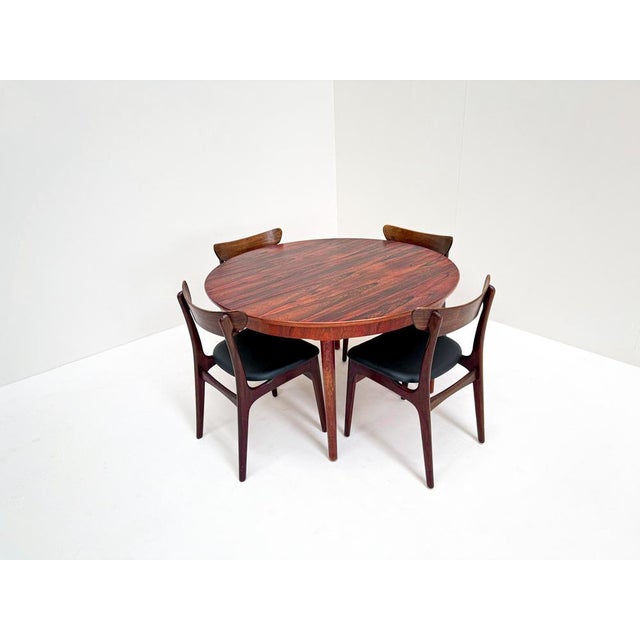 A stunning mid-century Danish dining set featuring six rare rosewood dining chairs designed by Schiønning & Elgaard for...