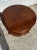 This coffee table is made out nof Mahogany wood. it's round and sits on 4 short legs. The top has a diamond parquet like...