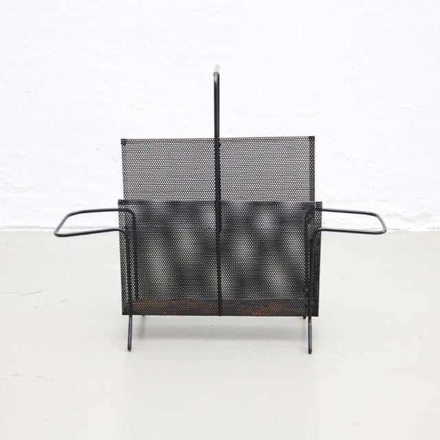 Magazine holder, designed by Mathieu Matégot. Manufactured by ateliers Matégot (France), circa 1950. Folded, perforated...