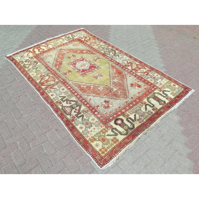 This beautiful, traditional vintage, hand knotted Turkish area rug is approximately 60 years old. It is handmade of very...