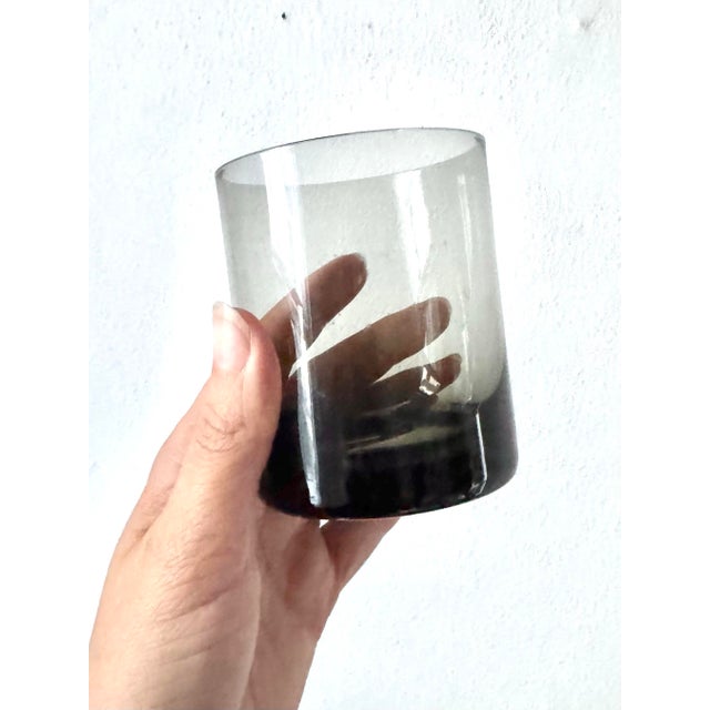 A fabulous collection of vintage Sasaki Coronation Smoke glassware, featuring smoky charcoal-gray bowls, sculptural clear...