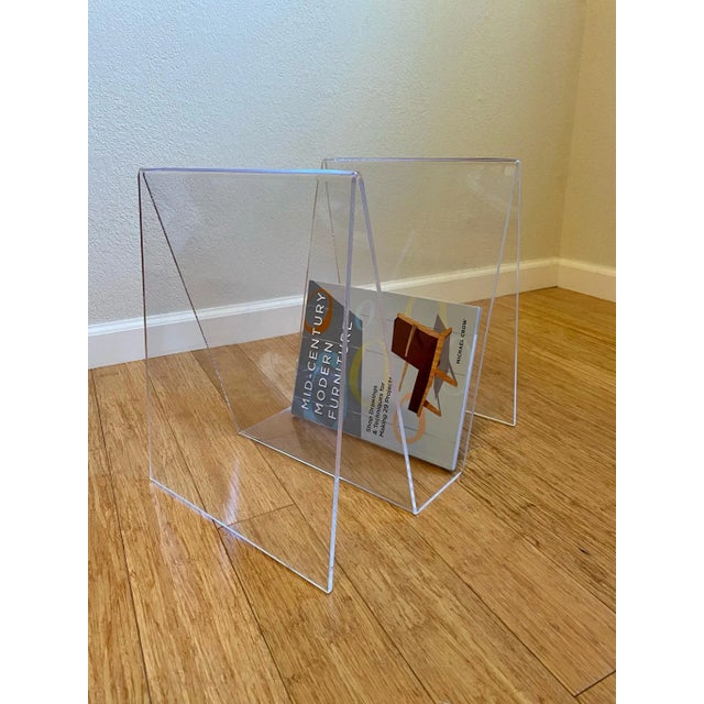 This vintage lucite magazine rack from the 70s is a mid century modern classic that is ready to hold everything from your...