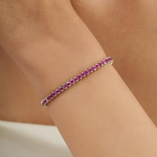This elegant 5.67 Ct natural ruby tennis bracelet features a continuous row of square-cut ruby gemstones, beautifully set...