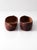 Vintage pair of carved wood clogs with a rich reddish-brown finish and incised geometric designs across the toes. Their...