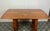 Vintage Art Deco dining table, dating from the 1930s. The table is primarily crafted from burr walnut, often featuring...