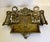 This beautiful antique brass inkwell stand features an ornate pierced design with scrolling details, fleur-de-lis motifs,...