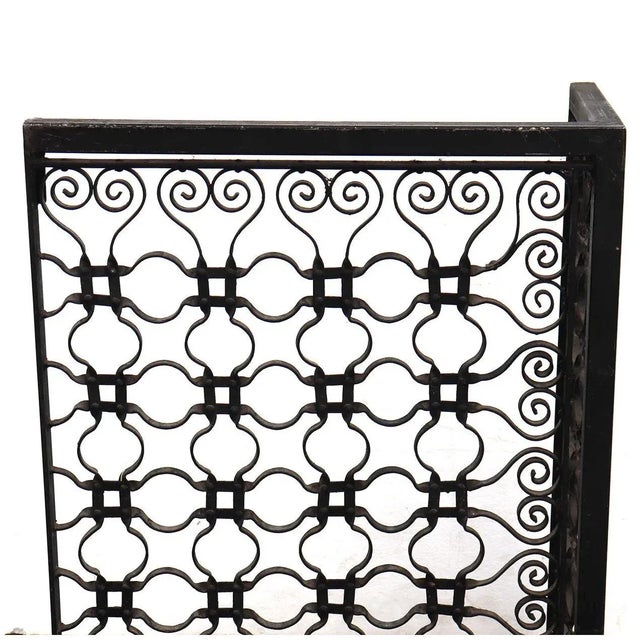 DETAILS An antique, three-part, fireplace screen repurposed from a Winslow Brothers iron mesh grille salvaged from a...