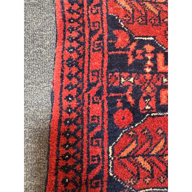 Design Plus Gallery presents a 4ft 4in × 6ft 8in Hand-Knotted Red Tribal Wool Area Rug. The rug has a red field with deep...