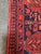 Design Plus Gallery presents a 4ft 4in × 6ft 8in Hand-Knotted Red Tribal Wool Area Rug. The rug has a red field with deep...