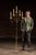 Freestanding wrought iron candelabra stand with a tall, slender central shaft rising from a tripod base formed by scrolled...