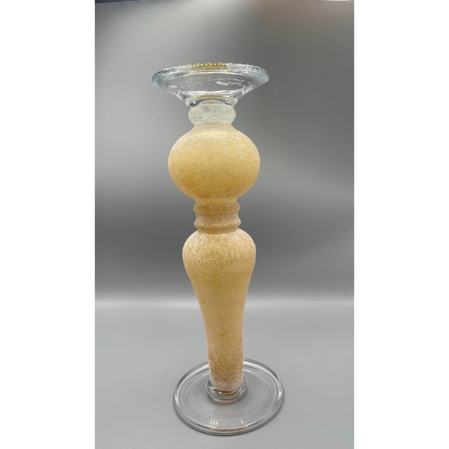 This substantial decorative candle holder features a classic urn-inspired silhouette with a broad flat top designed to...
