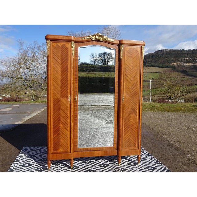 A high-quality linen cabinet crafted from fine materials. Beautiful marquetry with lemonwood trim, a very light wood....