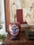 A richly detailed vintage chinoiserie table lamp featuring an Imari-inspired palette of deep burgundy, navy blue, dark...