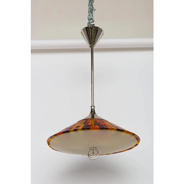 Italian pendant composed of colorful acrylic elements. Nickel-plated hardware with opaque glass diffuser. Ornamental metal...