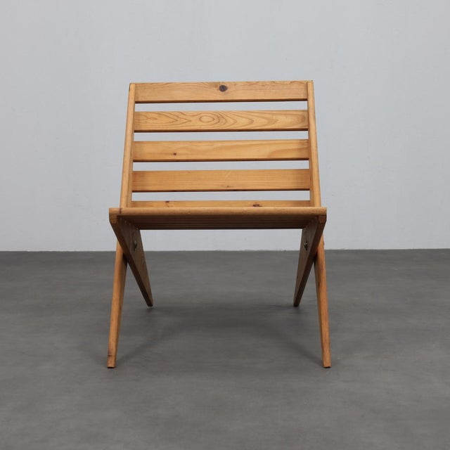 A Sculptural Study in Geometry and Craft. This striking 1970s folding chair captures the poetic simplicity of mid-century...