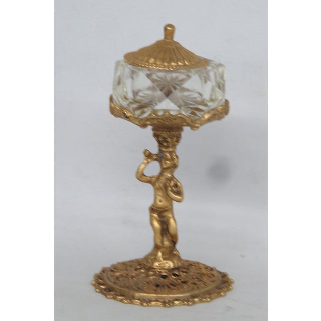 This gorgeous Salt Cellar is made of brass and glass. This stunning piece was made in the mid-twentieth century by the...