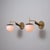 Pair of Italian wall sconces from the 1950s, each featuring a brass arm with angled geometry and a vertical finial,...