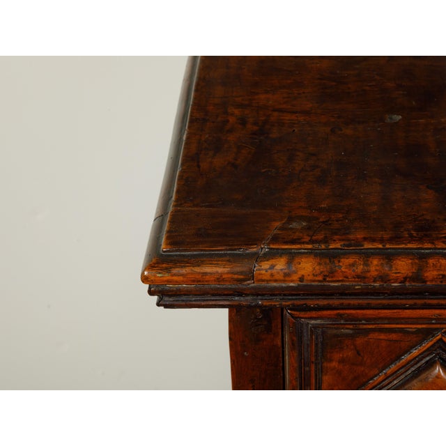 An Italian walnut commode from the early 19th century, with three drawers and raised diamond motifs. Created in Italy...