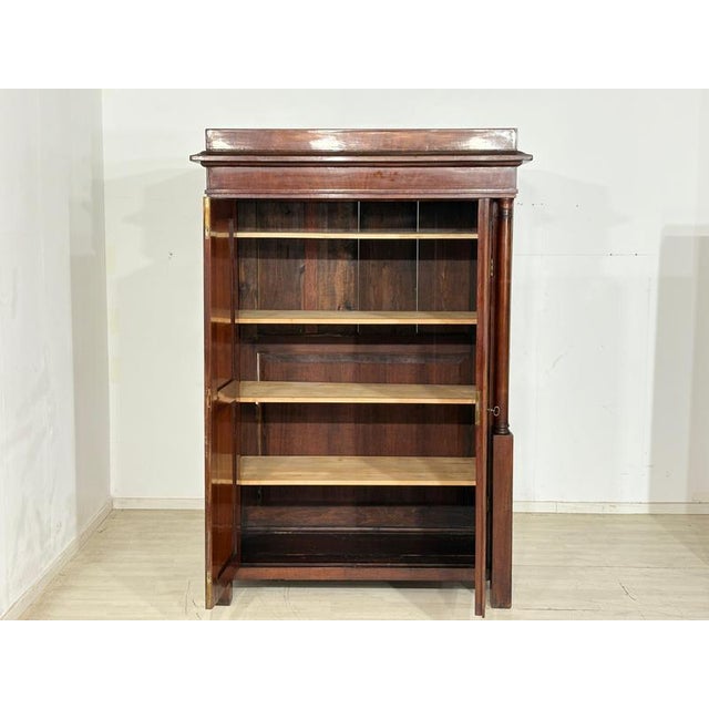 For sale is a classic, solid Biedermeier wardrobe made of fine wood, distinguished by its timeless elegance and...