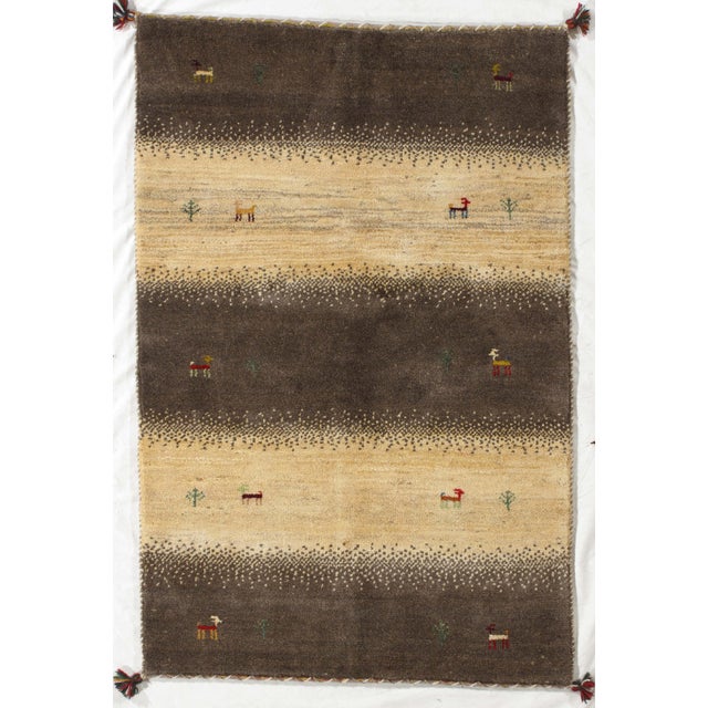 Vintage Persian hand-knotted Lori Gabbeh wool rug with horizontal bands in brown and cream tones and small stylized animal...