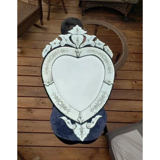 A fabulously decorated vintage Venetian glass mirror, Italian mic-century. Made of mirrored glass over a pine frame, the...