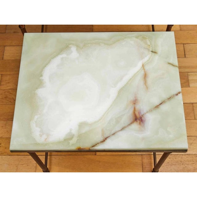 A trio of polished brass tables with onyx tops. Condition: the tops are expertly polished in a stonemason's workshop,...