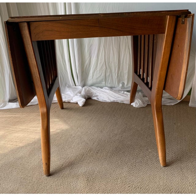 Mid century Danish modern-style drop leaf dining table by Garrison Furniture Company. The table features two retractable...