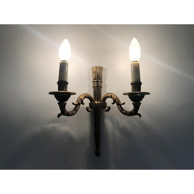 Empire Style Double Light Bronze Wall Sconce, 1960s Stunning bronze wall sconce dating from the 1960s. Finely decorated....