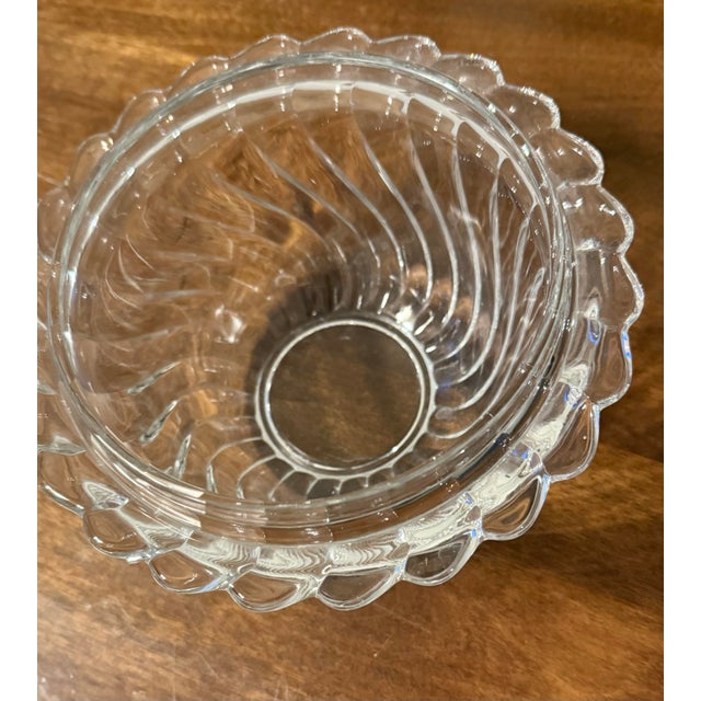 This is a rare Fostoria “Colony” ice bucket crafted from clear pressed glass or crystal. It features a distinctive swirl,...