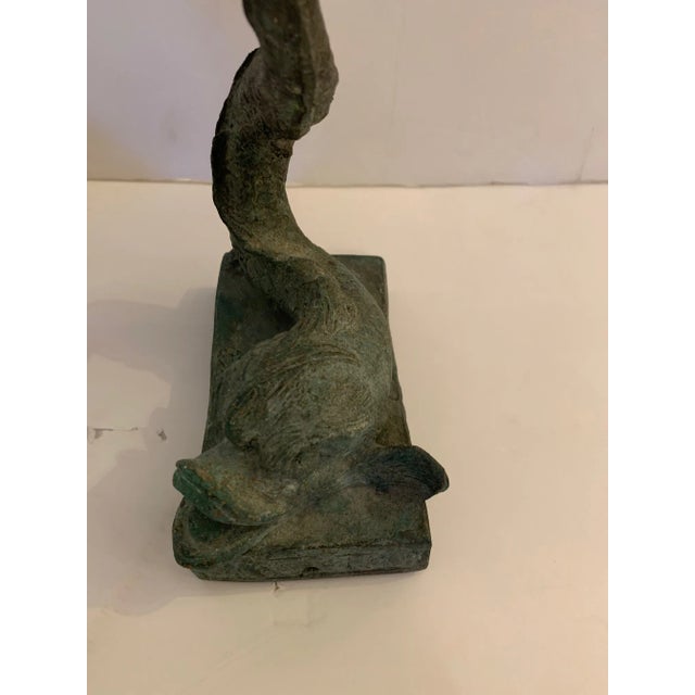 A pair of unusually expressionistic lead compotes having stylized elongated shape, earthy greenish black patina, and...