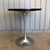 Tulip side table, I believe by Burke in the style of Saarinen. Aluminum base with laminate top. Age appropriate wear to...