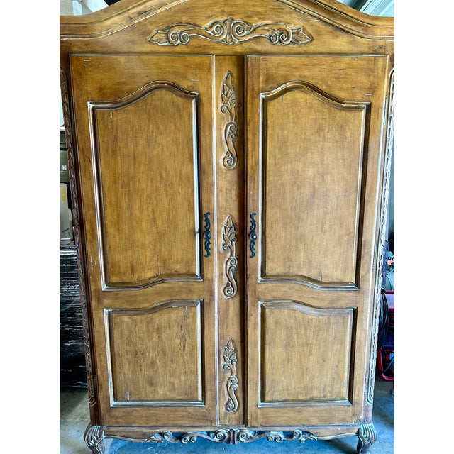 This beautiful Ethan Allen French Country style armoire desk is solid maple with a natural wood finish. It features a...