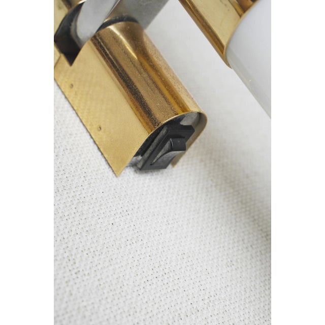 Pair of vintage italian murano glass wall sconces featuring long opaline white glass tubes, warm brass fittings in a...