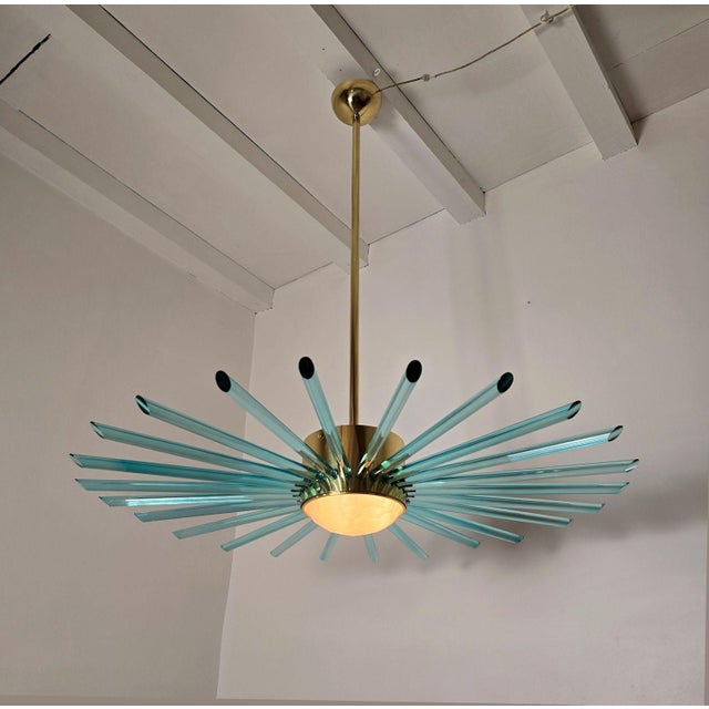 Large Mid Century Modern Sputnik chandelier, Italy 1980s. The chandelier is made of a polished brass frame and green plain...