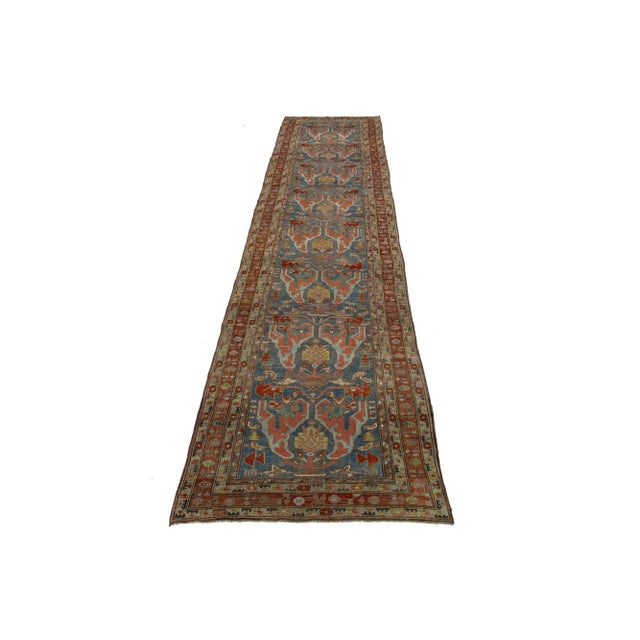 This Persian Bidjar wool rug features an antique charm, displaying flawless hand-knotted wool in a blue field. The floral...