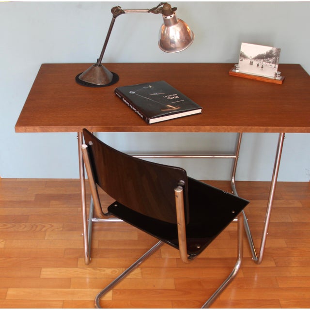 Bauhaus tubular steel desk, distinguished by its minimalist design. The oak veneer tabletop is in very good condition. The...