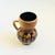 A mid century pottery vase produced by Lapid Pottery of Israel. Finished in a layered fat lava glaze of earth tone colors....