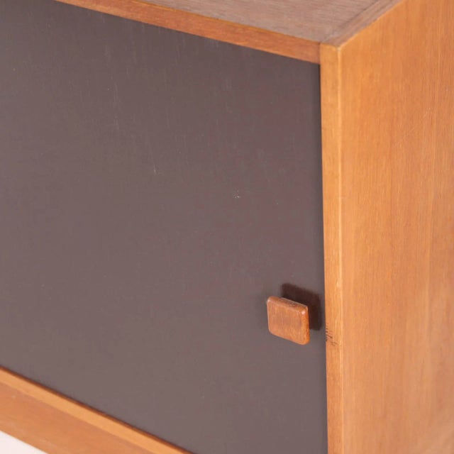 Little vintage danish sideboard with 4 drawers and one sliding door. Two patinas, unusual dimensions, original sticker....