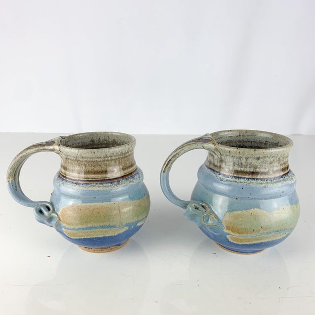 Incredible pair of handmade vintage studio pottery mugs. Twisted handles. Beautiful drippy glaze of green, blue, grey and...