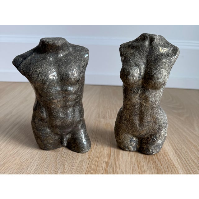 Pair of male and female torso sculptures carved from solid natural pyrite. Referencing the fragmented human forms of...