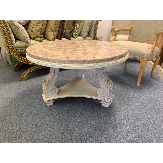 Pretty vintage French Neoclassical coffee table in the style of Rose Tarlow. The round top is made of a thick slab of...