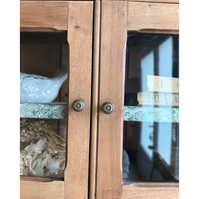A warbler suspended between a cabinet of curiosities and an antique apothecary cabinet. This small oak wall-mounted...