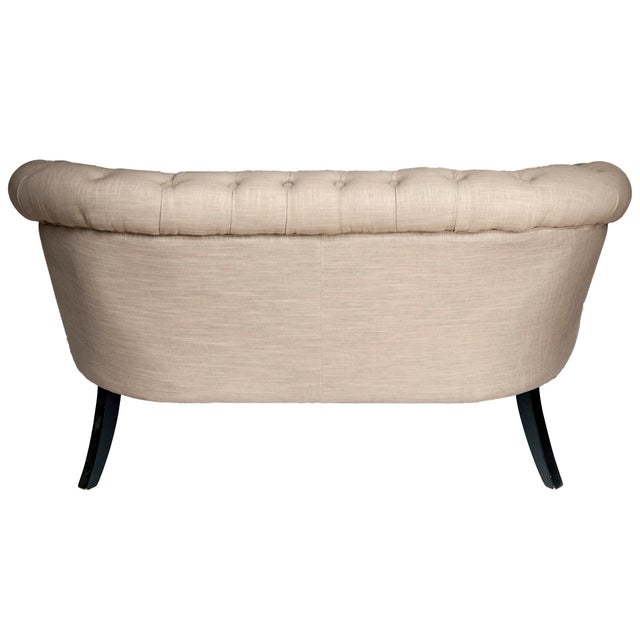 An Adorable Vintage English Style Tufted Loveseat upholstered in Linen. With metal tack detail, Black Legs and castor...
