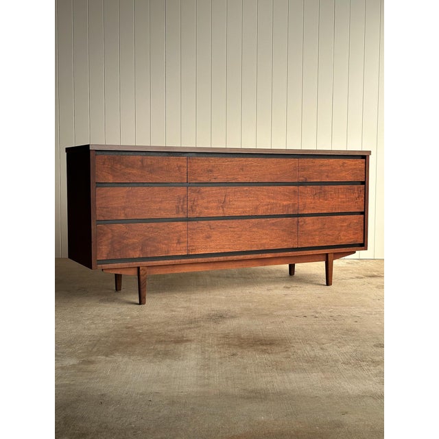 Vintage nine-drawer dresser by Stanley with solid walnut drawer fronts, veneered sides, and original laminate top....
