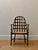 Oak armchair with pierced fretwork back and woven cane seat. A well-crafted vintage chair with timeless design and...