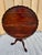 A classic Chippendale-style tilt-top tea table crafted from rich mahogany, featuring a generously sized 39 3/4” diameter...