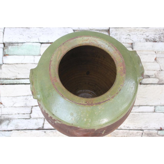 Absolutely gorgeous red and green clay antique pottery amphora with wide throat and two handles. This clay pot was...