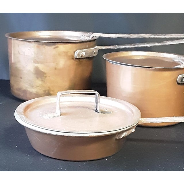 Vintage copper holloware , hand forged , 3 pans and 3 lids. Pan # 1 is 7.25 x 7.25" , length to end of handle 16", and 2'...
