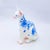This artwork features a delicately crafted Sphynx cat, rendered in a smooth resin cast adorned with intricate blue...