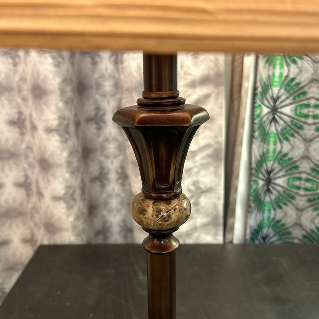 Table lamp made of bronze-color metal with center stone decoration. It comes complete with its custom matching silk shade....